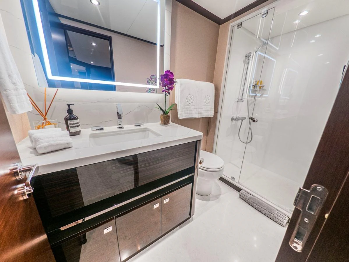 A luxurious yacht bathroom featuring modern fixtures and elegant decor. aboard LONE STAR Yacht for Sale