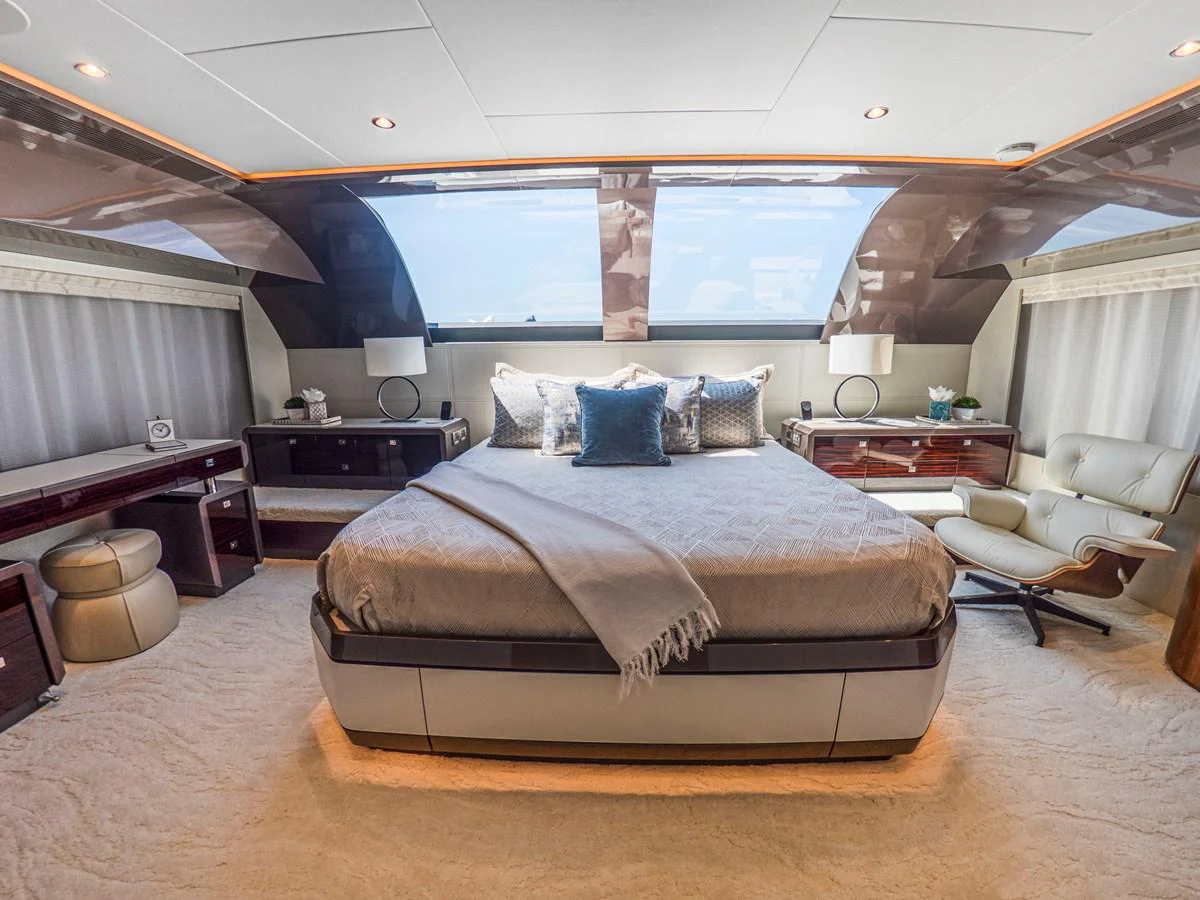 The master stateroom features a luxurious bed with elegant decor and ample natural light. aboard LONE STAR Yacht for Sale