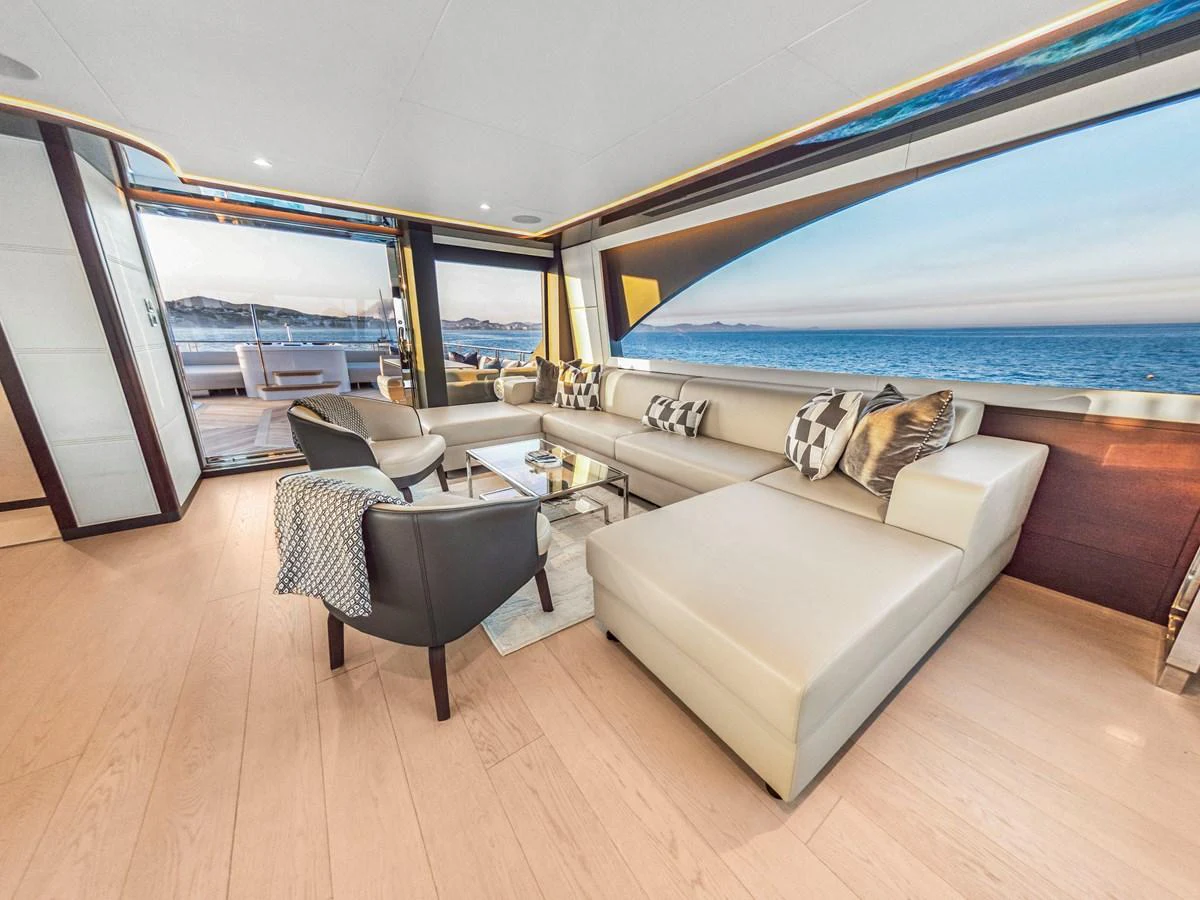 The salon offers a luxurious and spacious seating area with stunning ocean views through large windows. aboard LONE STAR Yacht for Sale