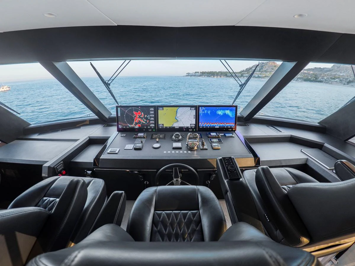 The helm station offers a commanding view with state-of-the-art navigation equipment and luxurious seating. aboard LONE STAR Yacht for Sale