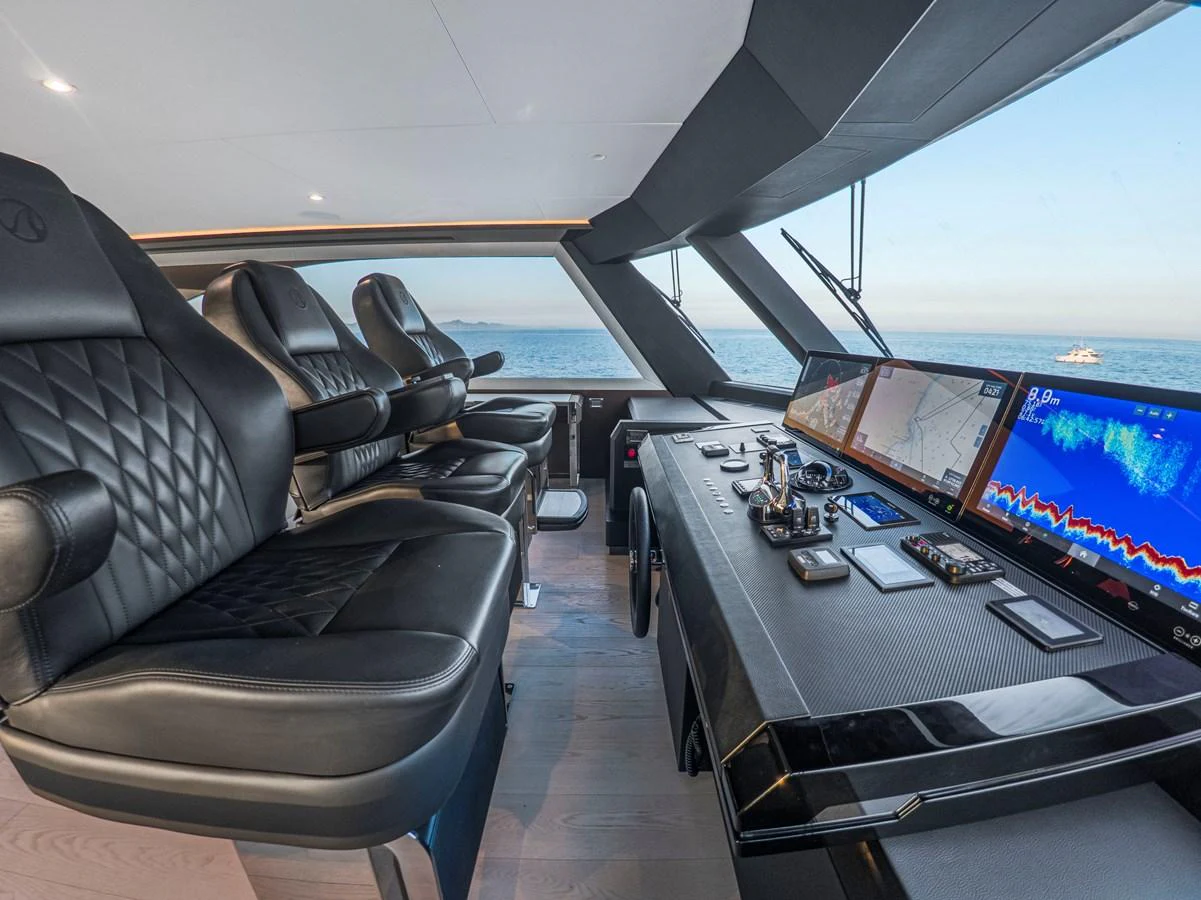 The helm station features luxurious seating and state-of-the-art navigation equipment with a panoramic view of the sea. aboard LONE STAR Yacht for Sale