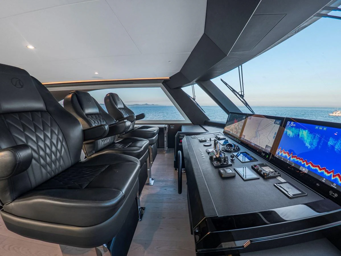 The helm station features advanced navigation equipment and luxurious seating with a panoramic view. aboard LONE STAR Yacht for Sale