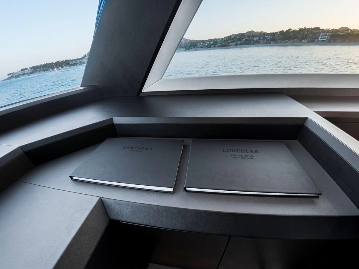 The yacht's interior features a sleek, modern design with large windows offering stunning sea views. aboard LONE STAR Yacht for Sale