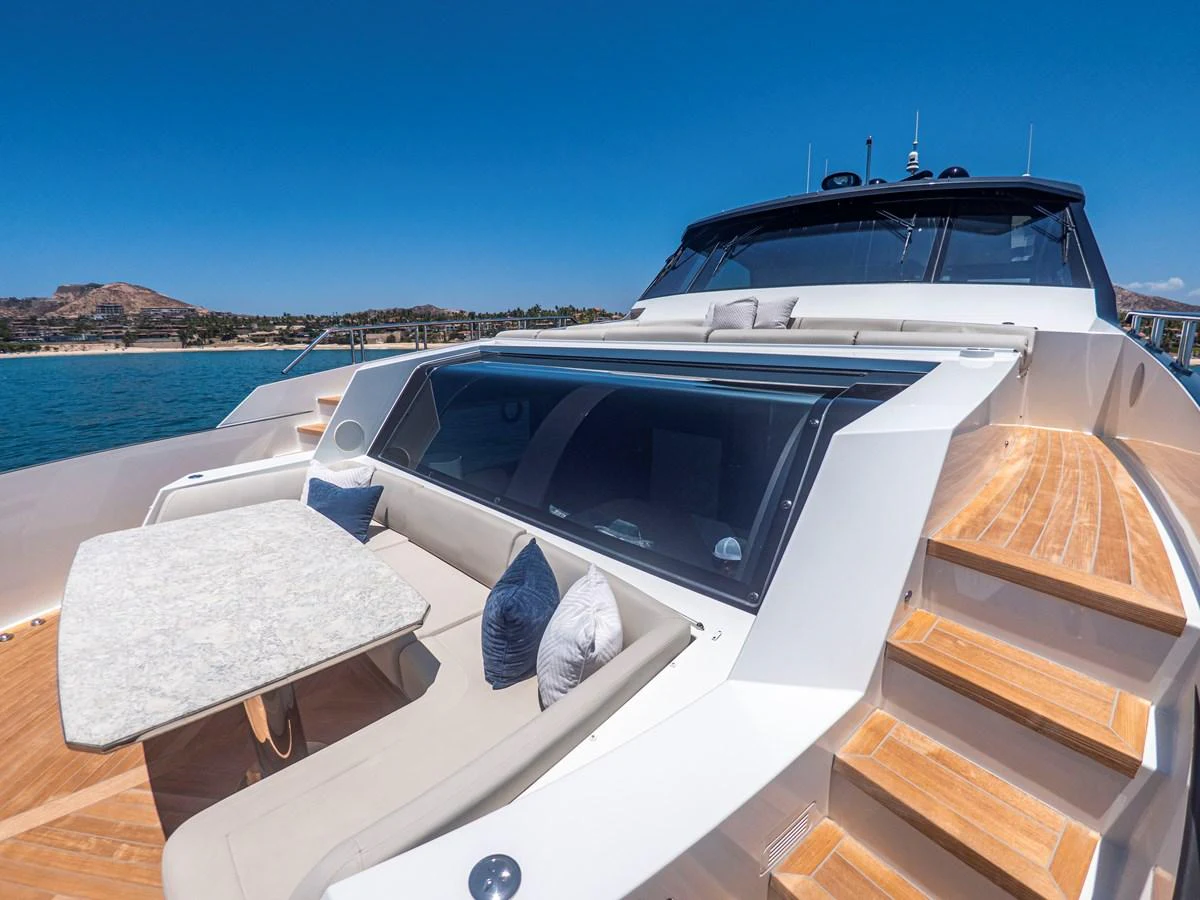 The foredeck of the yacht features a comfortable seating area with a table, perfect for enjoying the view. aboard LONE STAR Yacht for Sale