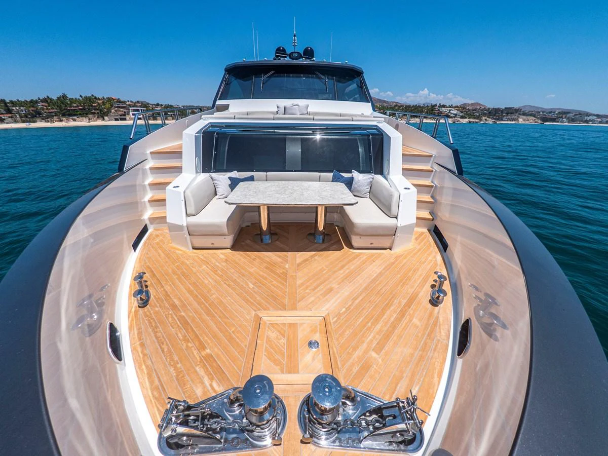 The yacht's foredeck features a stylish seating area with a table, perfect for enjoying the ocean views. aboard LONE STAR Yacht for Sale