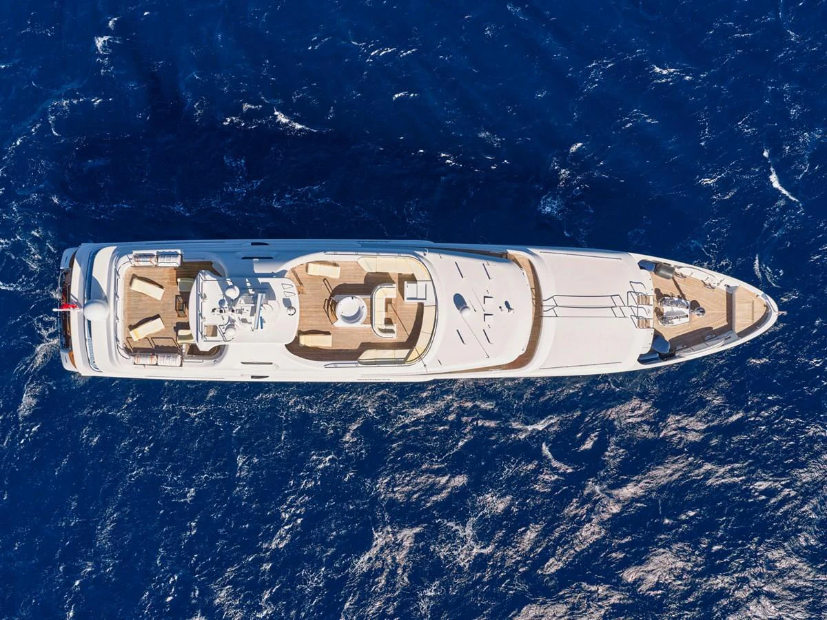 An aerial view of a luxurious yacht cruising through deep blue waters. aboard SAHAB IV Yacht for Sale