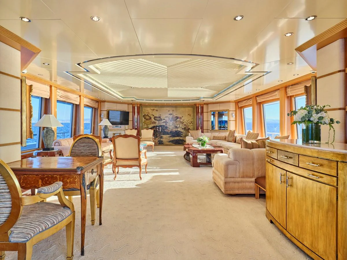 The salon features elegant furnishings and expansive windows, creating a bright and inviting atmosphere. aboard SAHAB IV Yacht for Sale