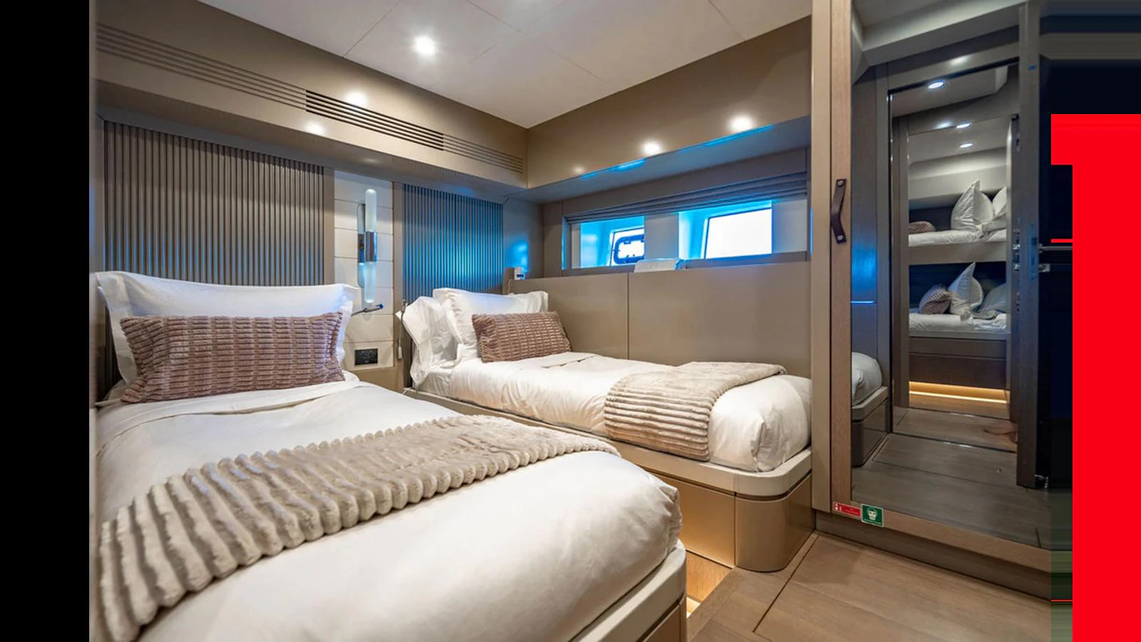The guest stateroom features twin beds with luxurious bedding and modern decor. aboard NIVASA Yacht for Sale