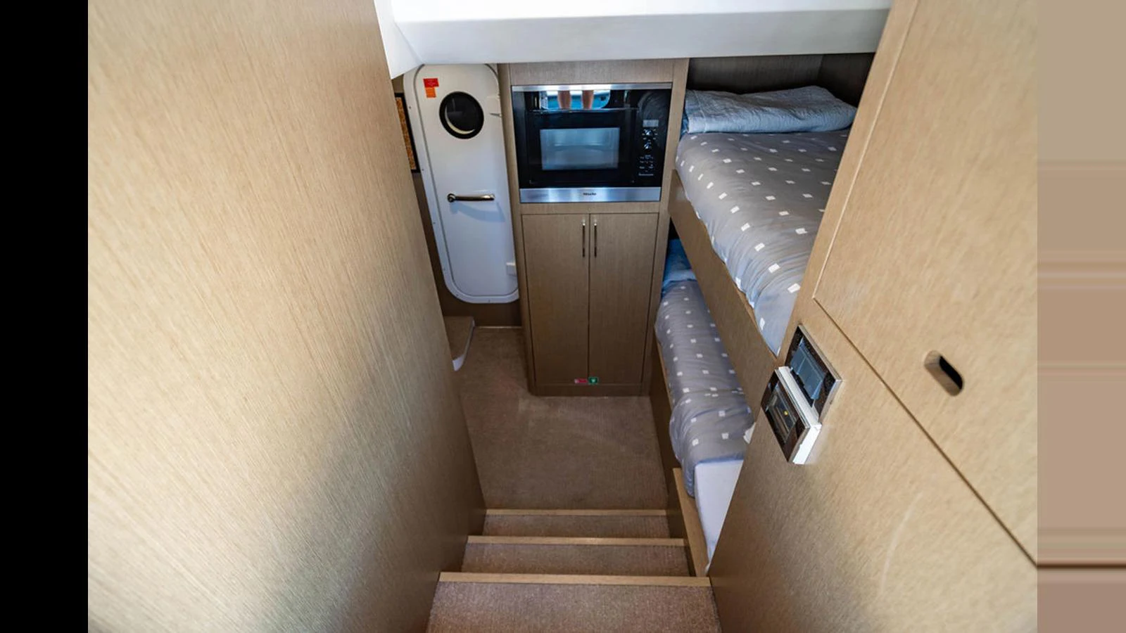 The cozy crew quarters feature bunk beds and a compact kitchenette area. aboard NIVASA Yacht for Sale