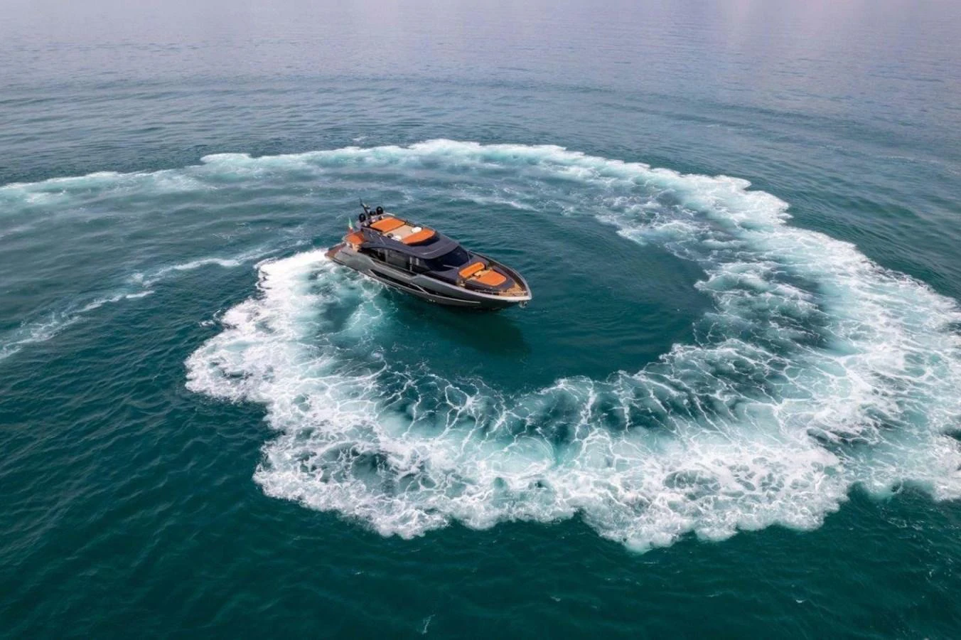 A sleek yacht creates a stunning circular wake as it maneuvers on the open water. aboard AB 100/05 Yacht for Sale