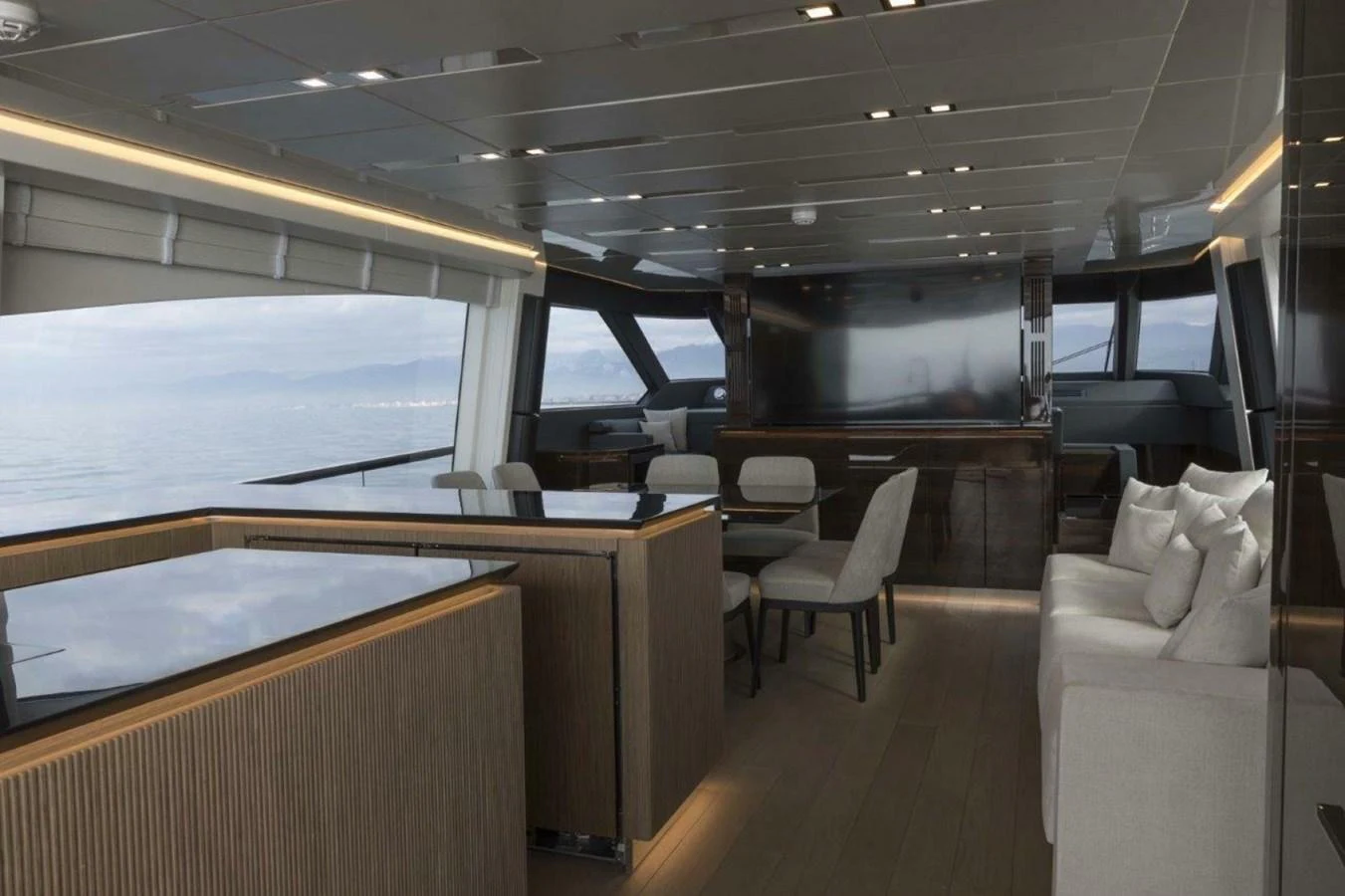 The salon features modern furnishings with panoramic views through large windows. aboard AB 100/05 Yacht for Sale