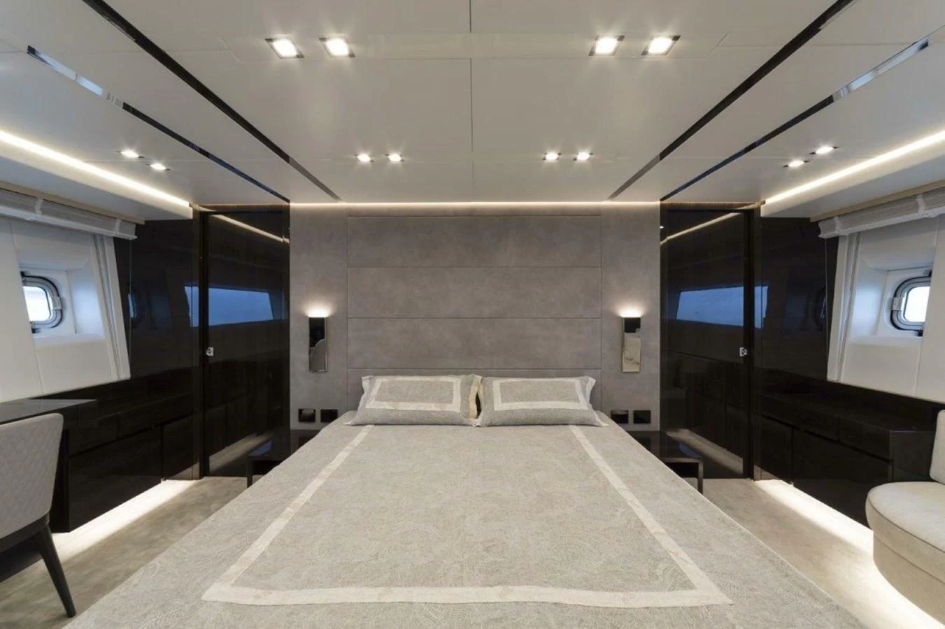 The master stateroom features a luxurious bed with modern lighting and sleek design elements. aboard AB 100/05 Yacht for Sale