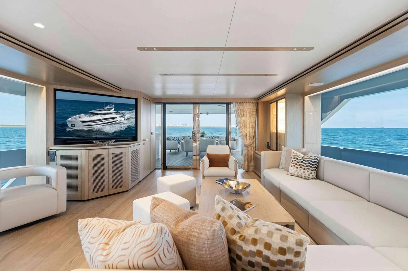 The salon offers a spacious and luxurious seating area with panoramic ocean views. aboard THE ROCK Yacht for Sale