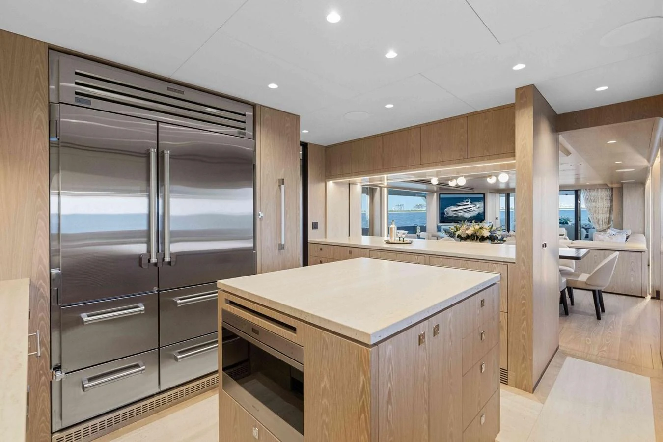 The galley features modern appliances and ample counter space, seamlessly blending into the open-plan layout. aboard THE ROCK Yacht for Sale