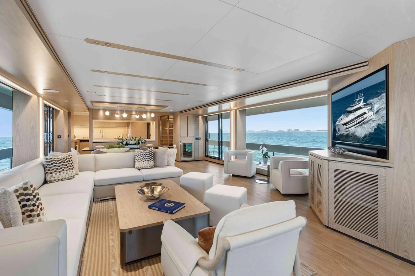 The spacious salon offers luxurious seating with panoramic ocean views and modern entertainment amenities. aboard THE ROCK Yacht for Sale