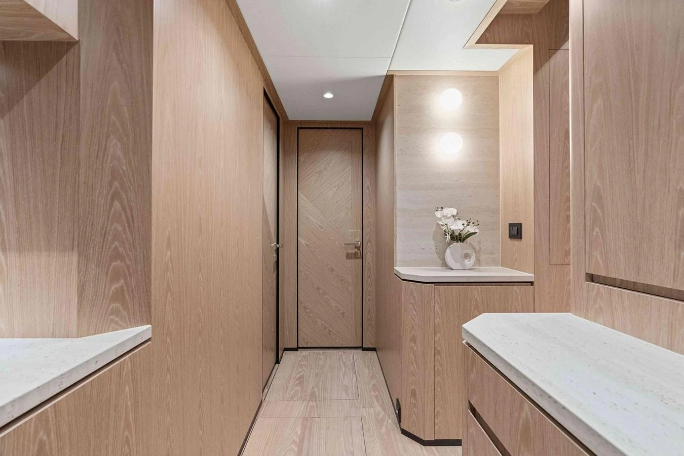 The yacht's interior hallway features elegant wood paneling and modern lighting. aboard THE ROCK Yacht for Sale