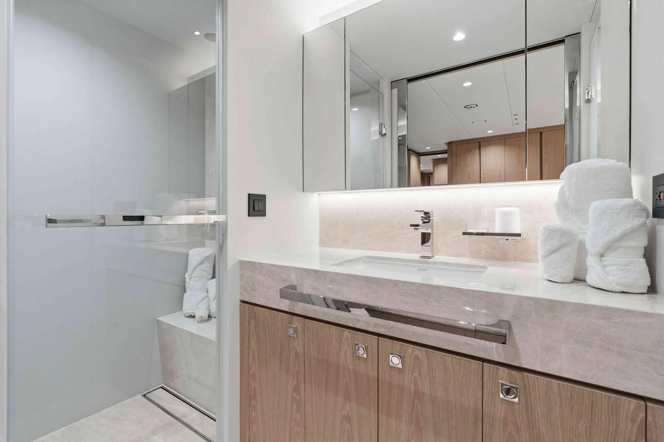 The yacht's bathroom features modern fixtures and a sleek design with ample storage. aboard THE ROCK Yacht for Sale