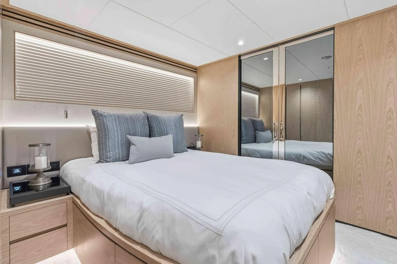 The stateroom features a comfortable bed with elegant bedding and ample storage space. aboard THE ROCK Yacht for Sale