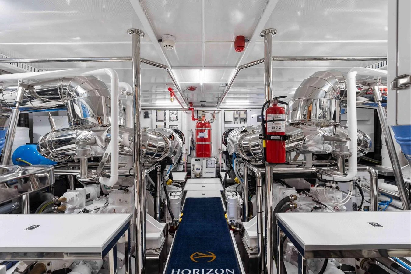 The engine room showcases a pristine and well-organized space with polished metal components and advanced machinery. aboard THE ROCK Yacht for Sale
