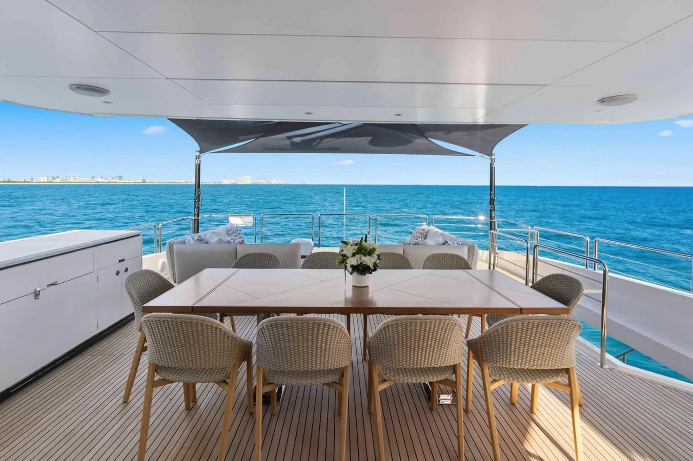 The aft deck offers a spacious and elegant dining area with stunning ocean views. aboard THE ROCK Yacht for Sale
