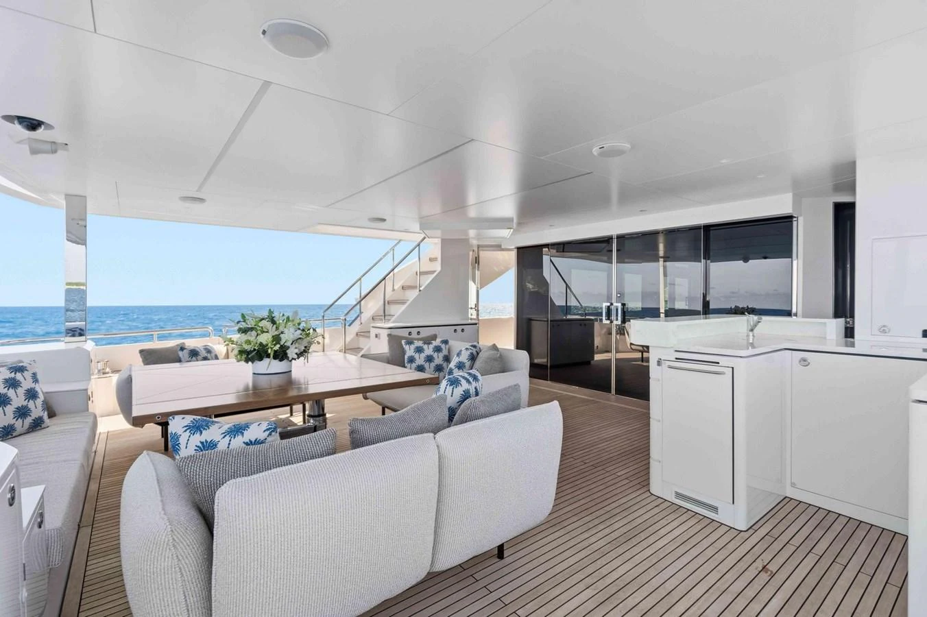 The aft deck features a spacious seating area with elegant furnishings and a beautiful ocean view. aboard THE ROCK Yacht for Sale