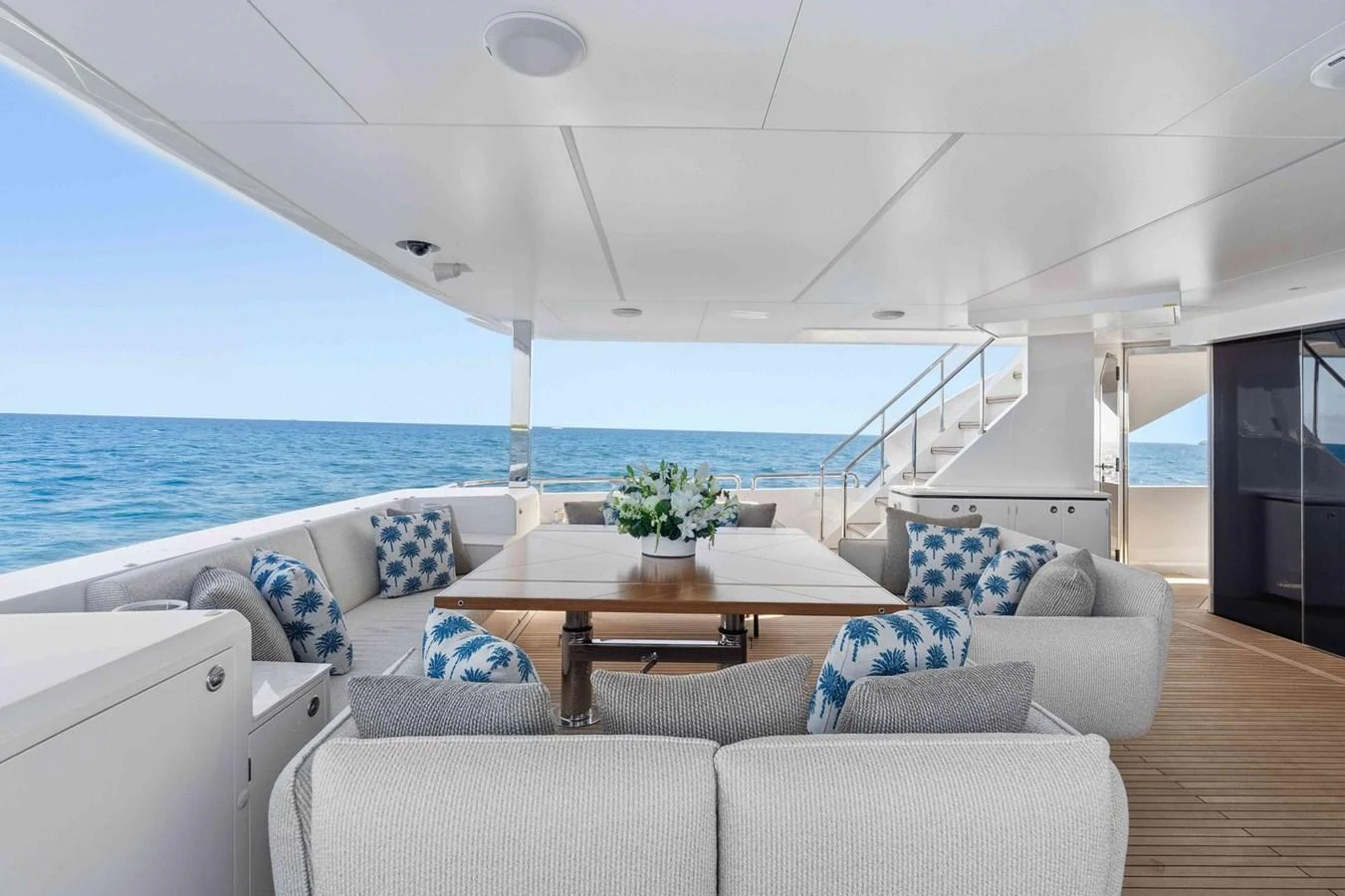 The aft deck offers a spacious and comfortable seating area with a stunning ocean view. aboard THE ROCK Yacht for Sale