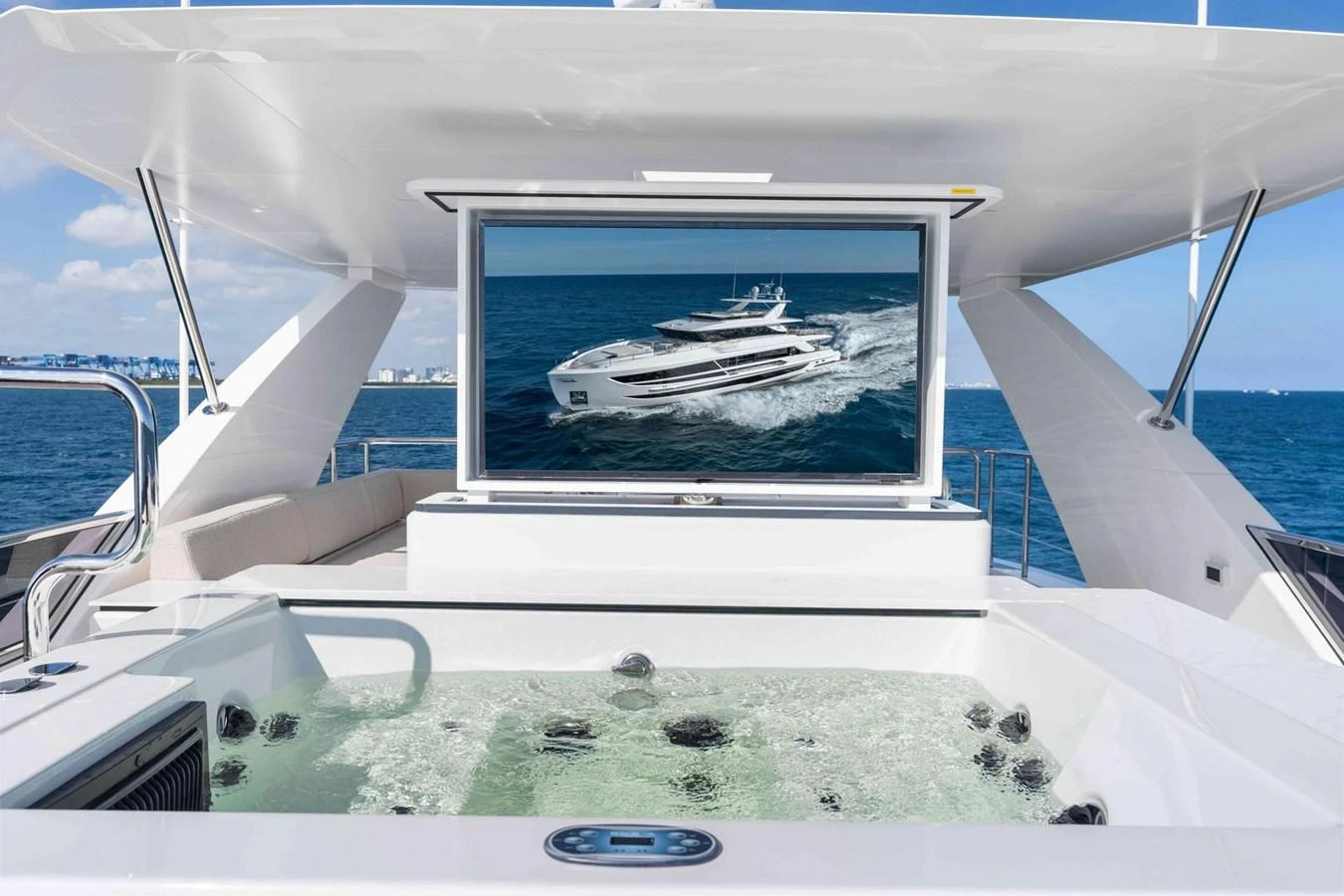 The sundeck features a luxurious jacuzzi with a retractable TV screen, offering a perfect blend of relaxation and entertainment. aboard THE ROCK Yacht for Sale