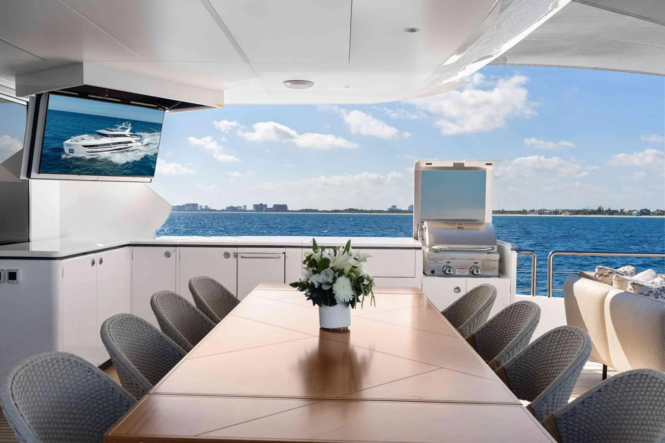 The aft deck features a spacious dining area with a stunning ocean view. aboard THE ROCK Yacht for Sale