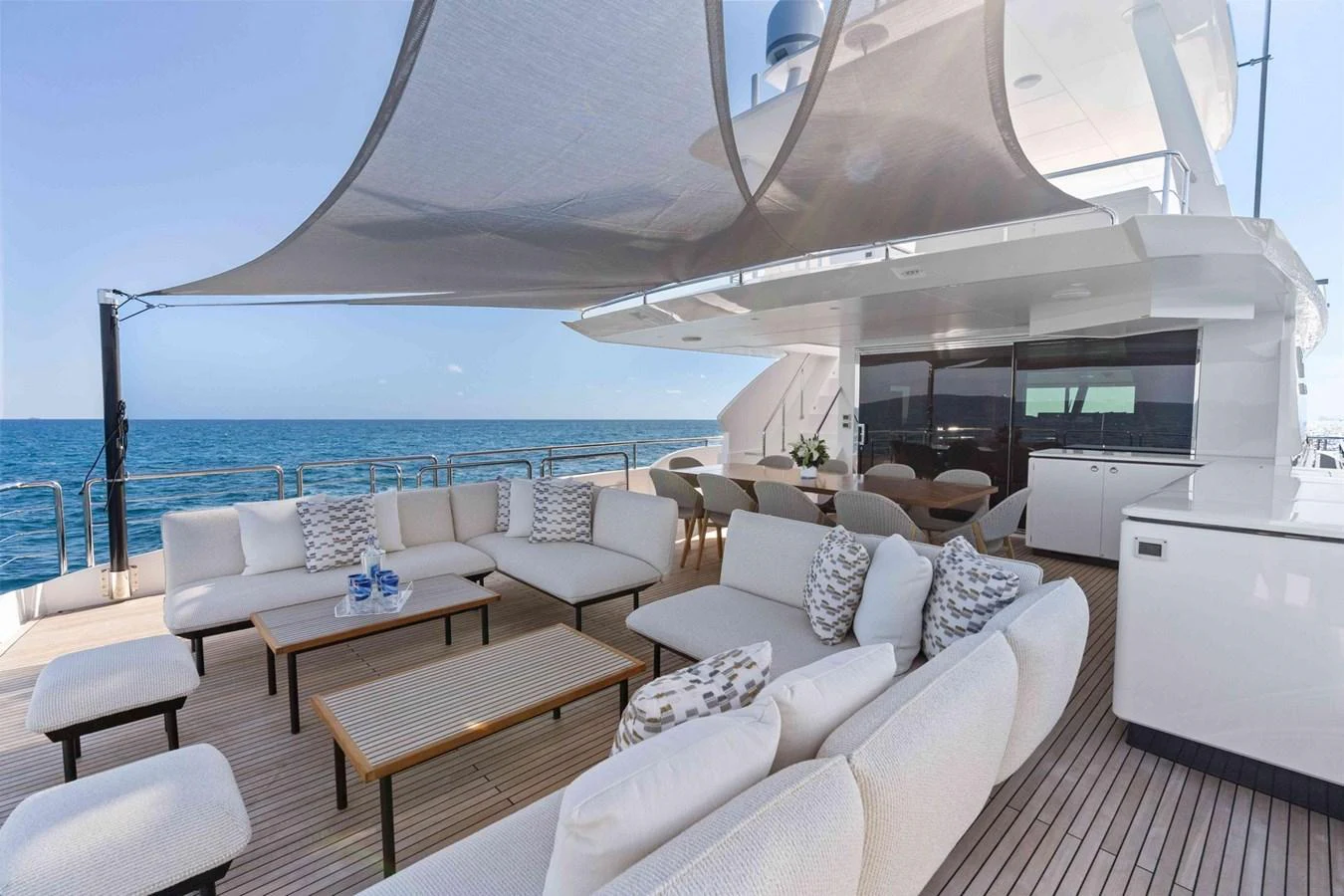The aft deck offers a spacious and luxurious outdoor seating area with elegant furnishings and ocean views. aboard THE ROCK Yacht for Sale