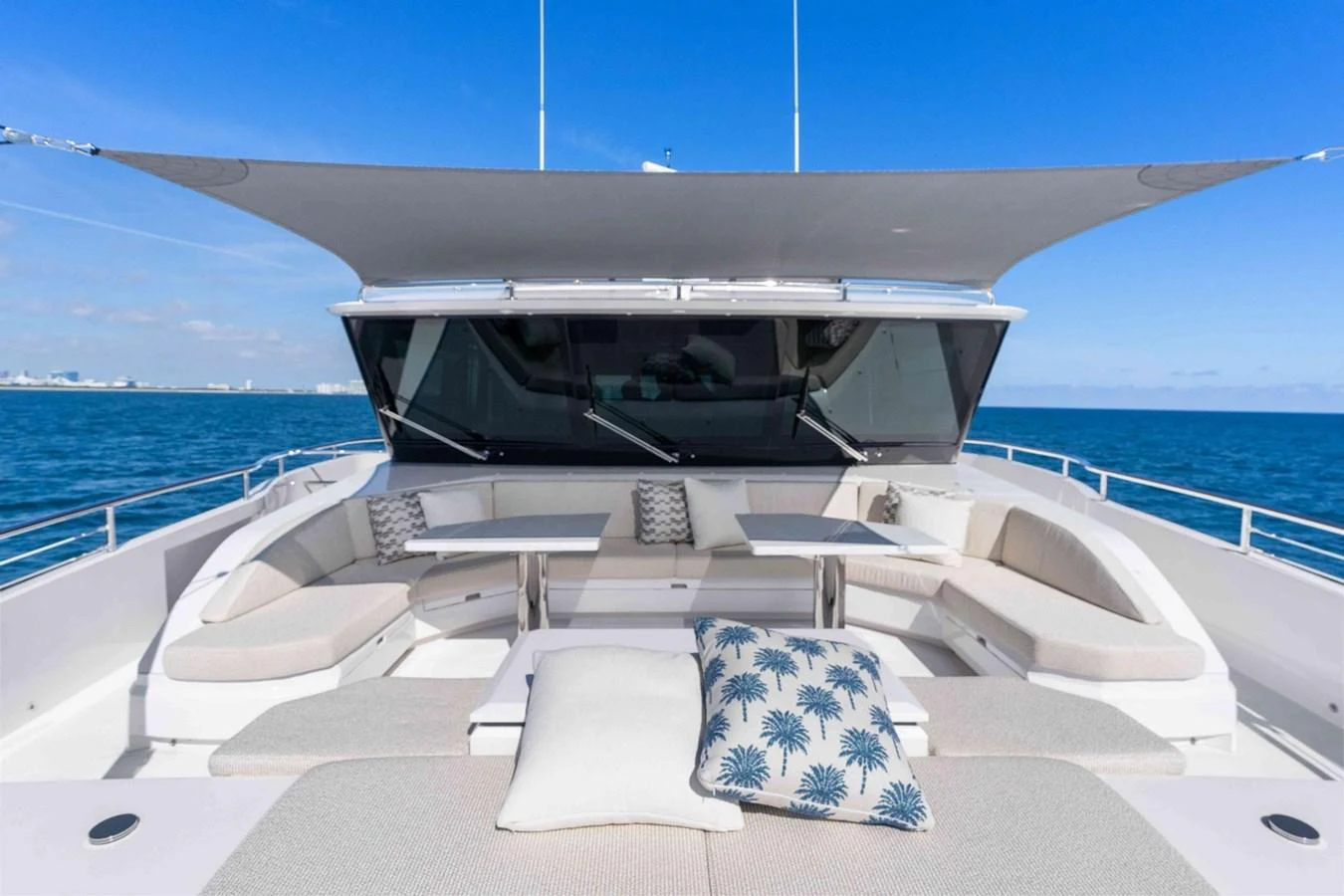 The flybridge offers a spacious and comfortable seating area with a sunshade and stunning ocean views. aboard THE ROCK Yacht for Sale