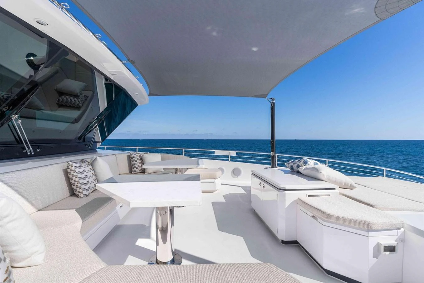 The flybridge offers a spacious and luxurious outdoor seating area with stunning ocean views. aboard THE ROCK Yacht for Sale