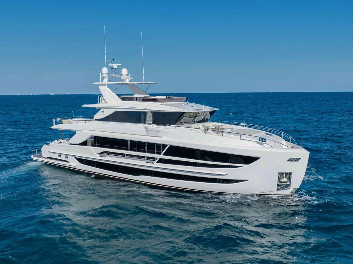 A sleek and modern yacht cruising on the open sea under a clear blue sky. aboard THE ROCK Yacht for Sale