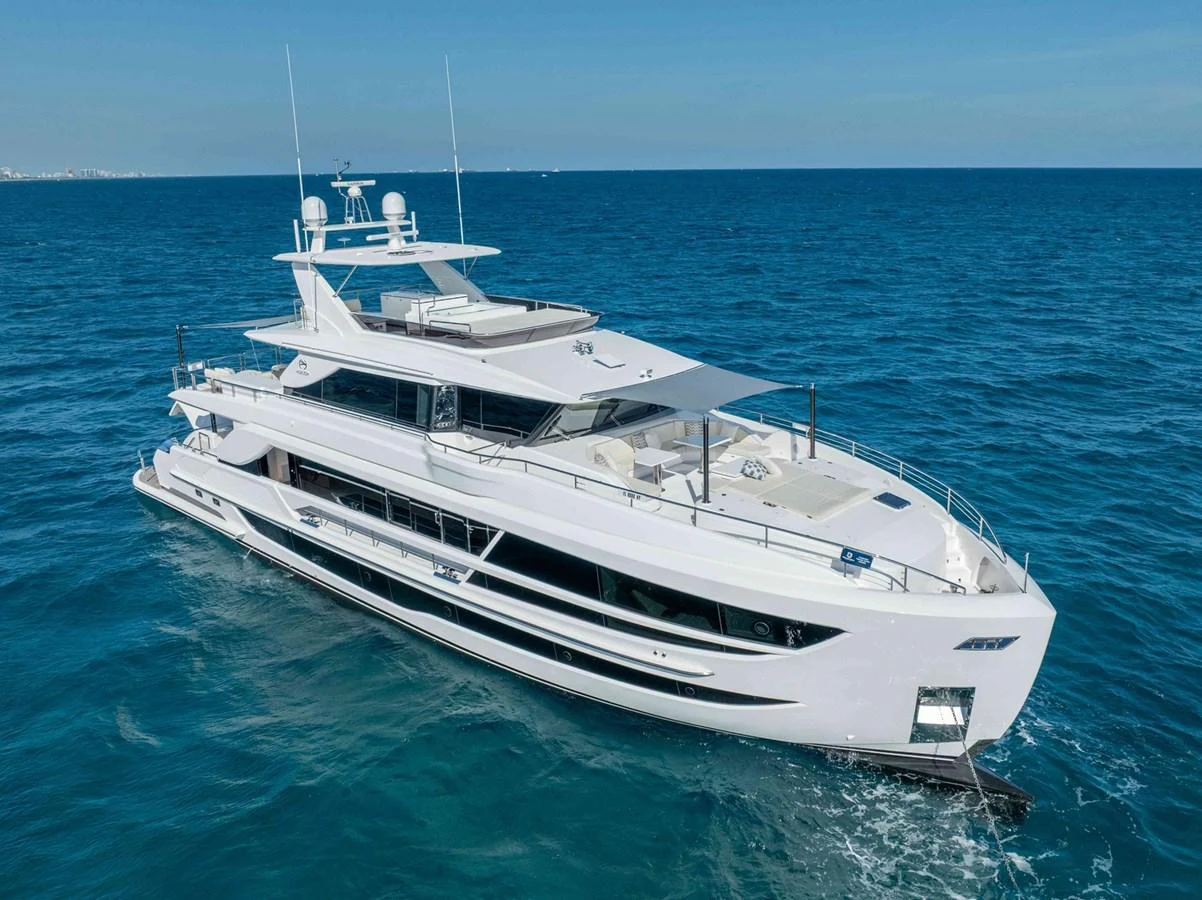 A sleek and modern yacht cruising on clear blue waters under a bright sky. aboard THE ROCK Yacht for Sale