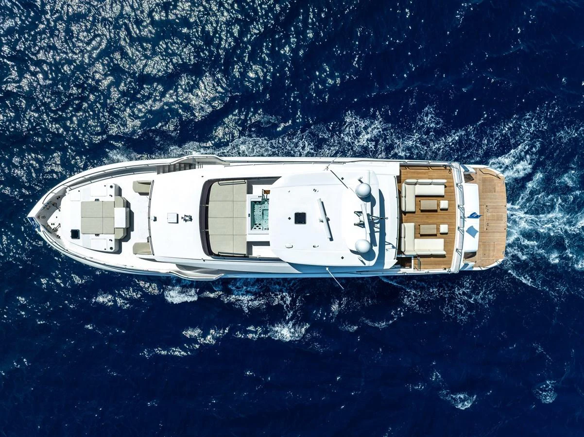 Aerial view of a luxurious yacht cruising through deep blue waters. aboard THE ROCK Yacht for Sale