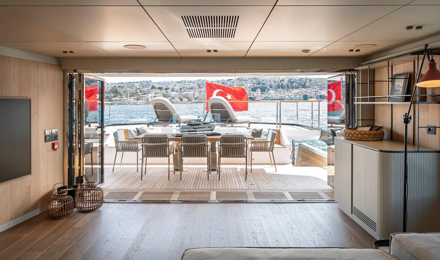 The salon opens up to an inviting aft deck with a dining area and scenic views. aboard NUMARINE 30XP#3 Yacht for Sale