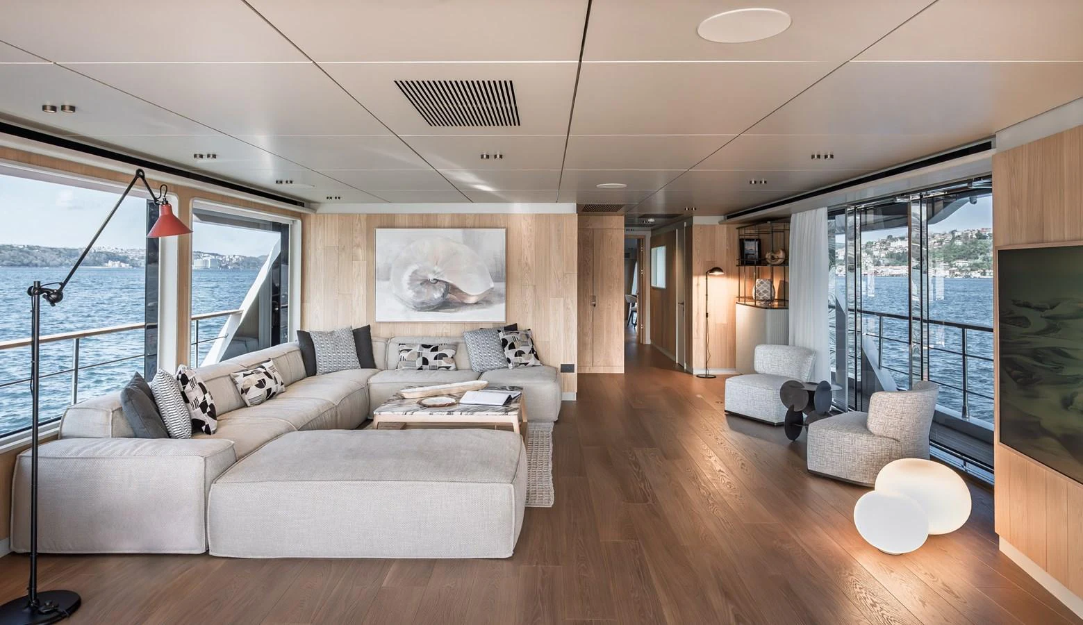 The spacious salon features modern furnishings and expansive windows with stunning water views. aboard NUMARINE 30XP#3 Yacht for Sale