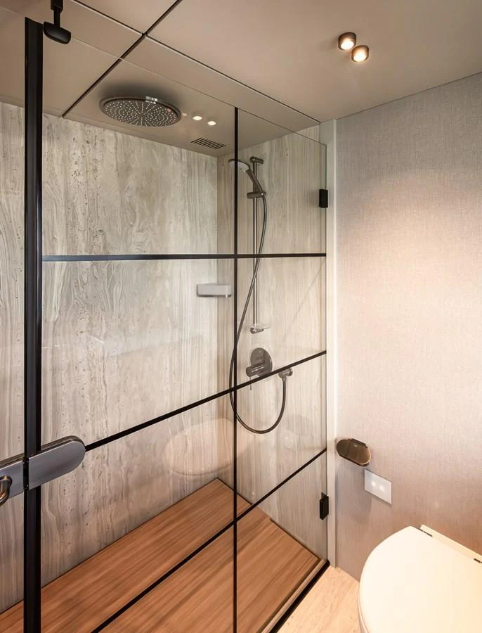 A modern yacht bathroom with a glass-enclosed shower and sleek fixtures. aboard NUMARINE 30XP#3 Yacht for Sale