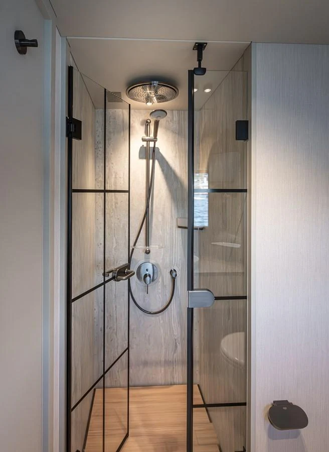 A sleek and modern shower area with glass doors and high-end fixtures. aboard NUMARINE 30XP#3 Yacht for Sale