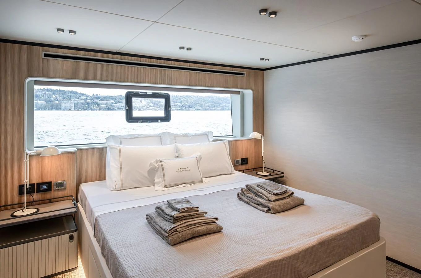 A serene stateroom with a large window offering a stunning view of the water. aboard NUMARINE 30XP#3 Yacht for Sale