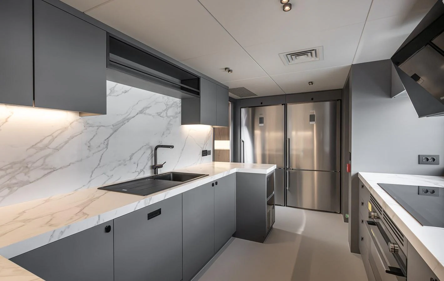 The yacht's galley features sleek, modern design with high-end appliances and marble countertops. aboard NUMARINE 30XP#3 Yacht for Sale