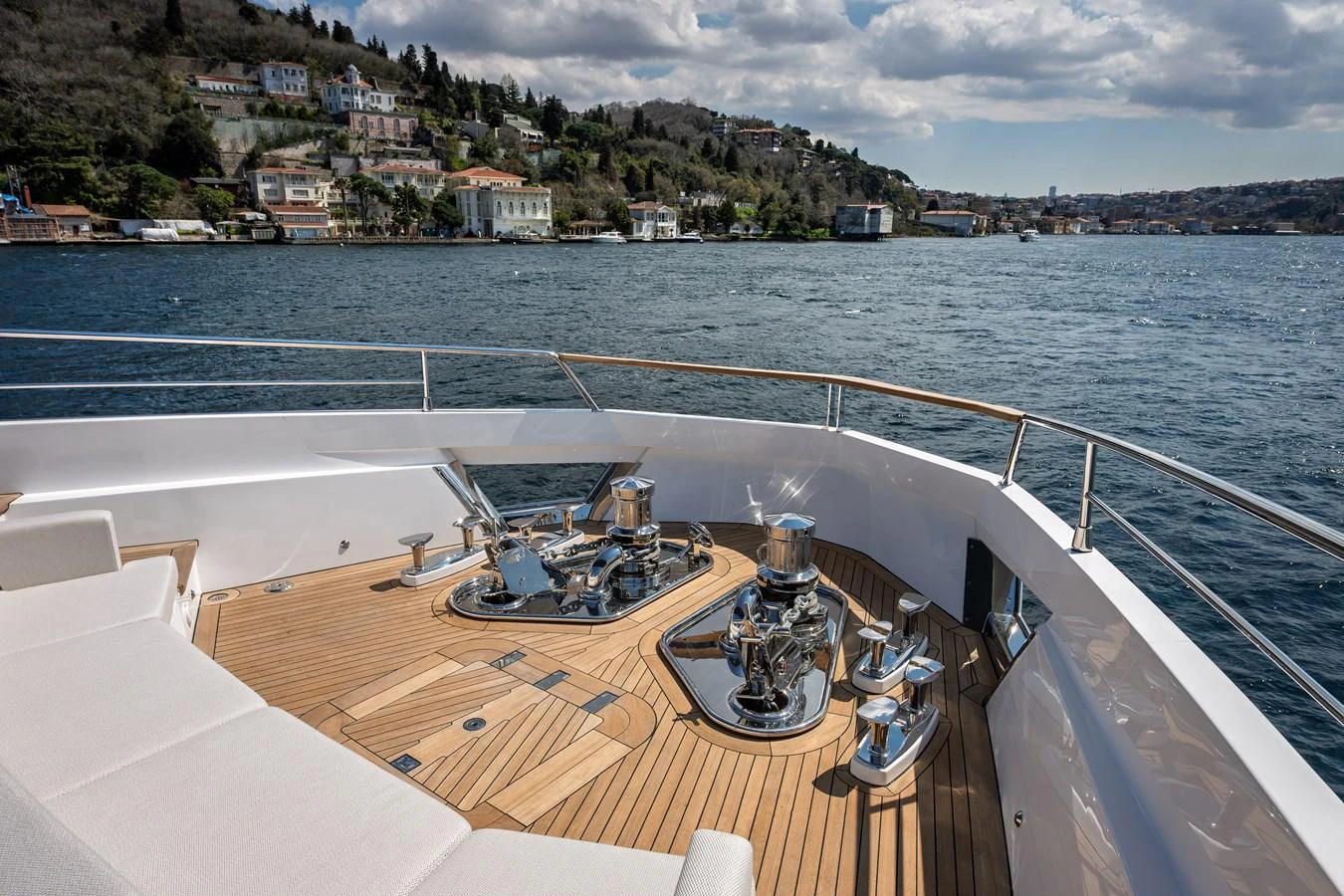 The foredeck features a spacious teak deck with polished stainless steel fittings, offering a stunning view of the coastline. aboard NUMARINE 30XP#3 Yacht for Sale
