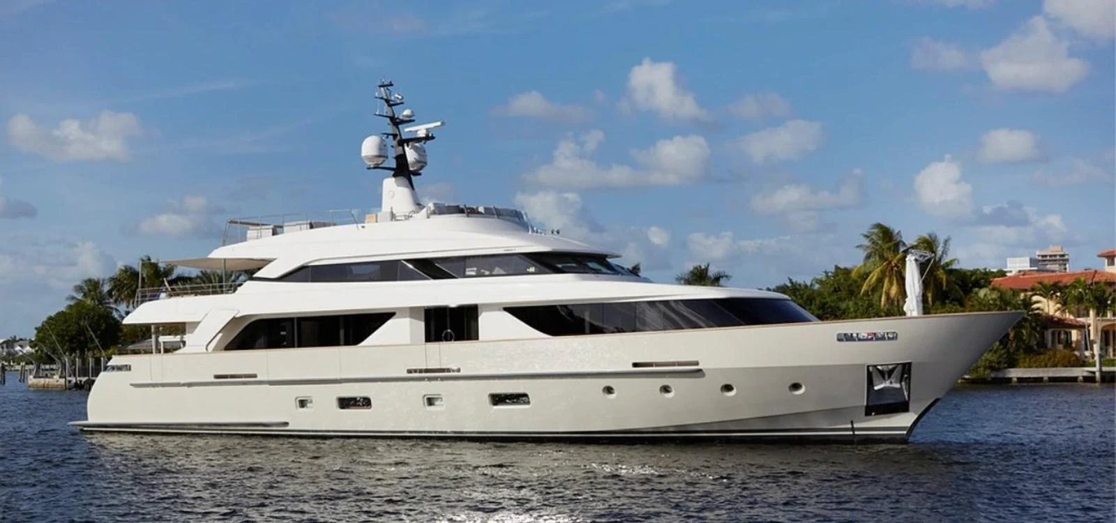 A sleek and modern yacht cruising on calm waters under a clear blue sky. aboard O Yacht for Sale
