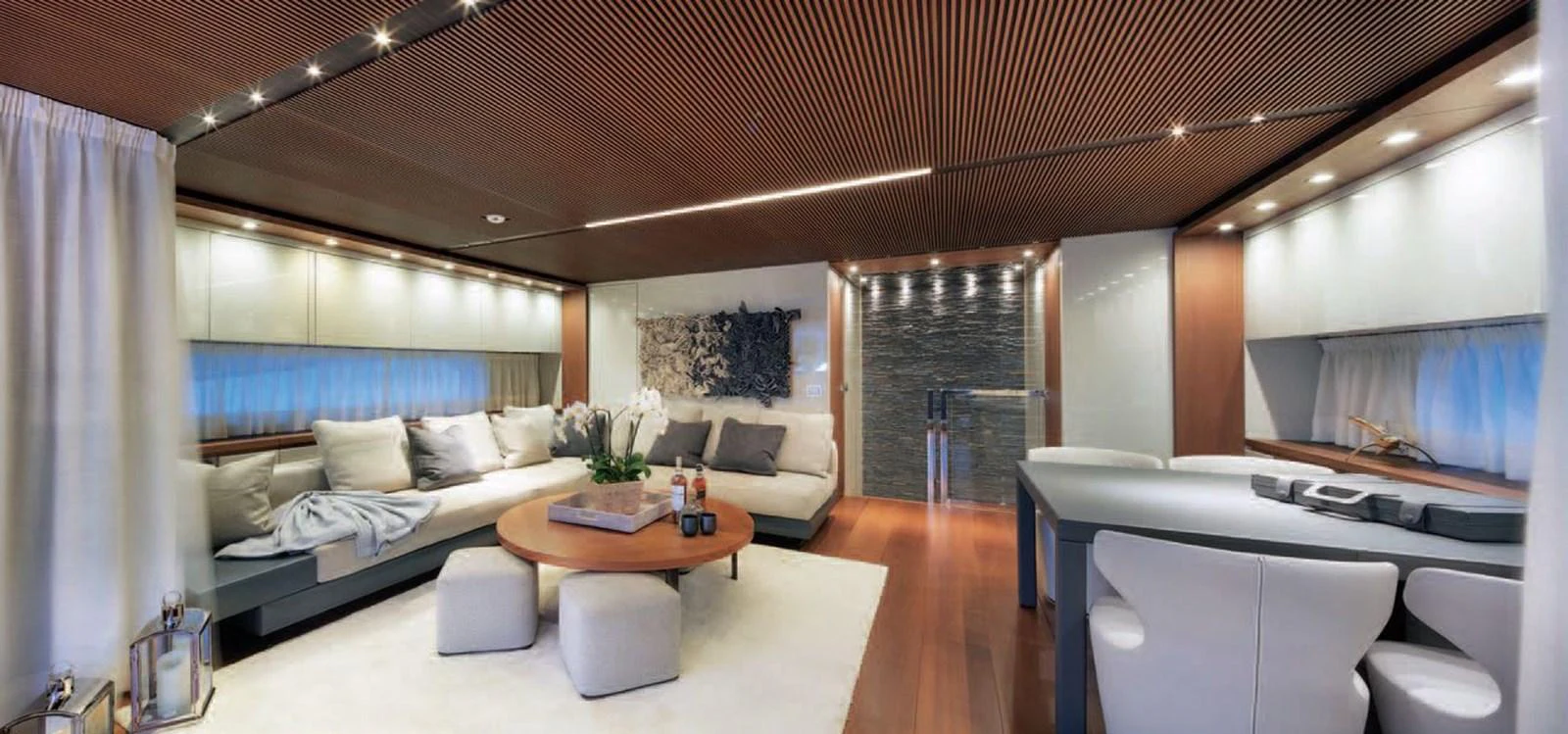 The spacious salon features elegant seating, a modern coffee table, and sophisticated lighting. aboard O Yacht for Sale
