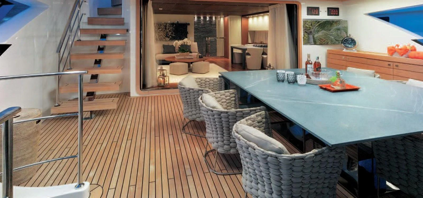 The yacht features a stylish dining area with a large table and comfortable seating, seamlessly connected to the interior living space. aboard O Yacht for Sale