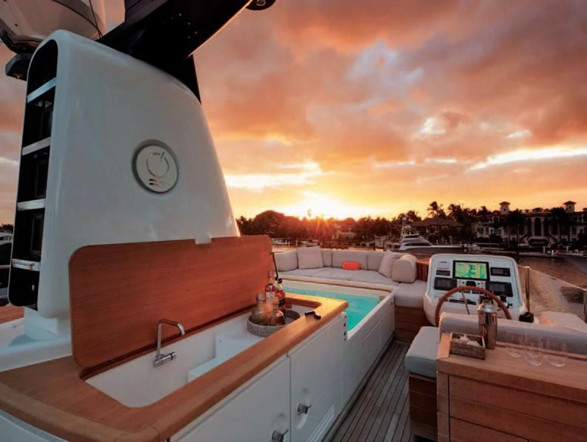 The sundeck features a luxurious hot tub and a well-equipped bar area, perfect for sunset relaxation. aboard O Yacht for Sale