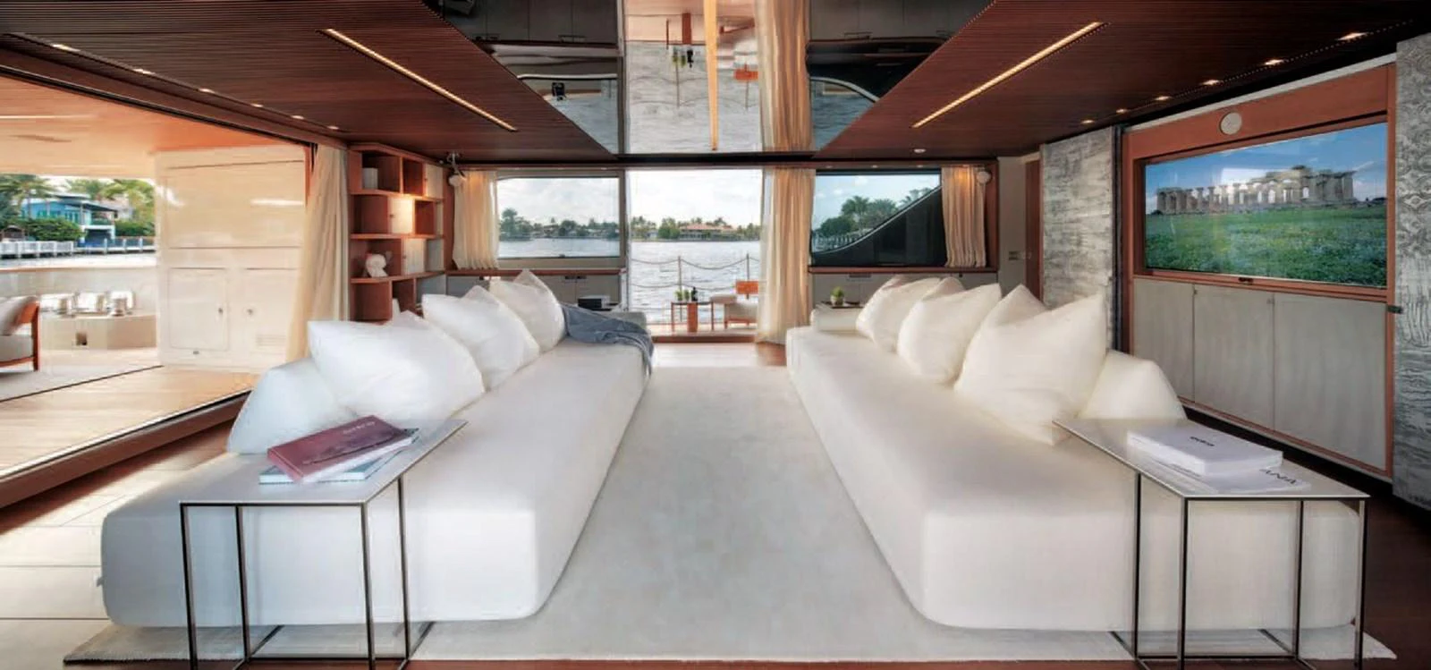 The salon features plush seating, elegant decor, and expansive views through large windows. aboard O Yacht for Sale