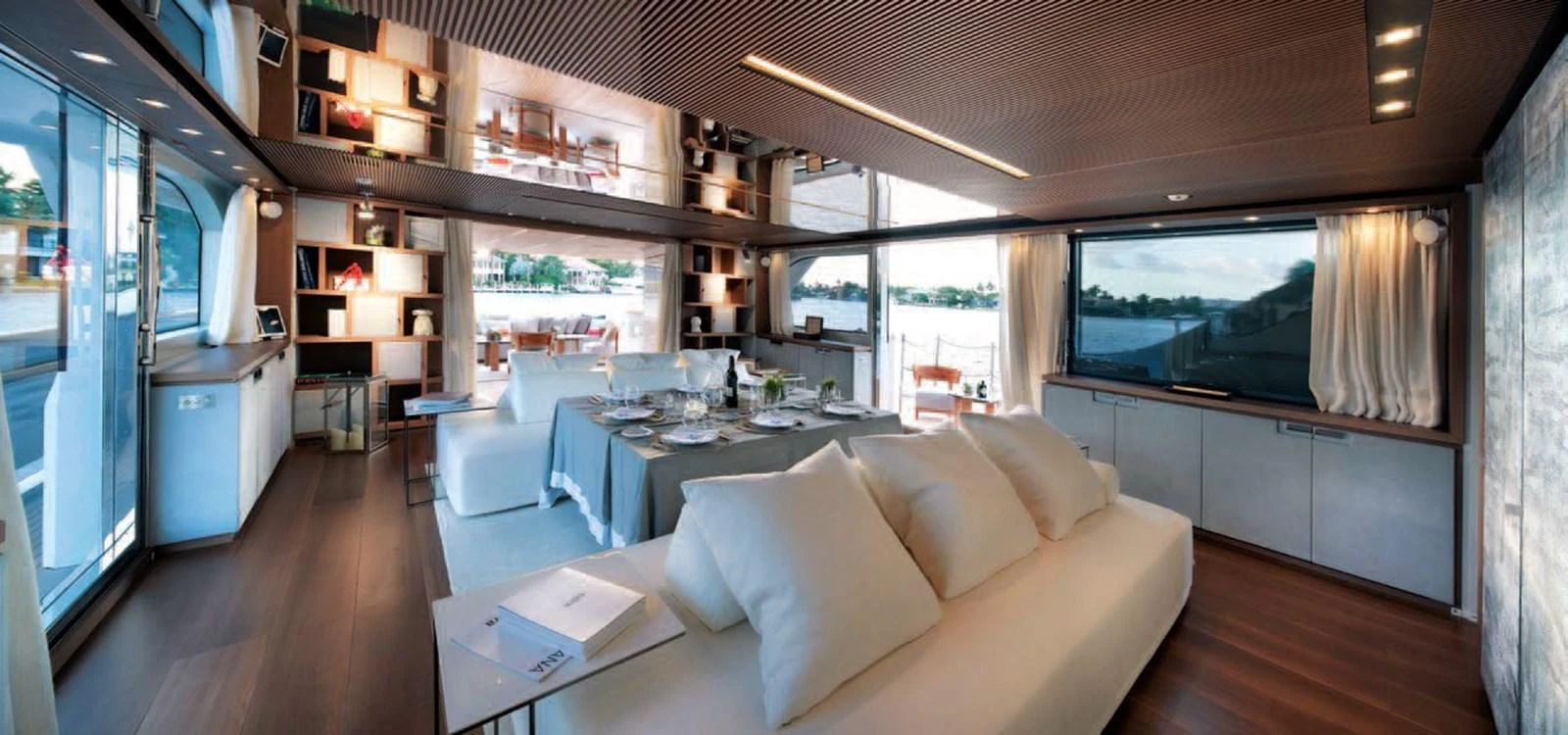The spacious salon features modern furnishings and large windows offering panoramic views. aboard O Yacht for Sale