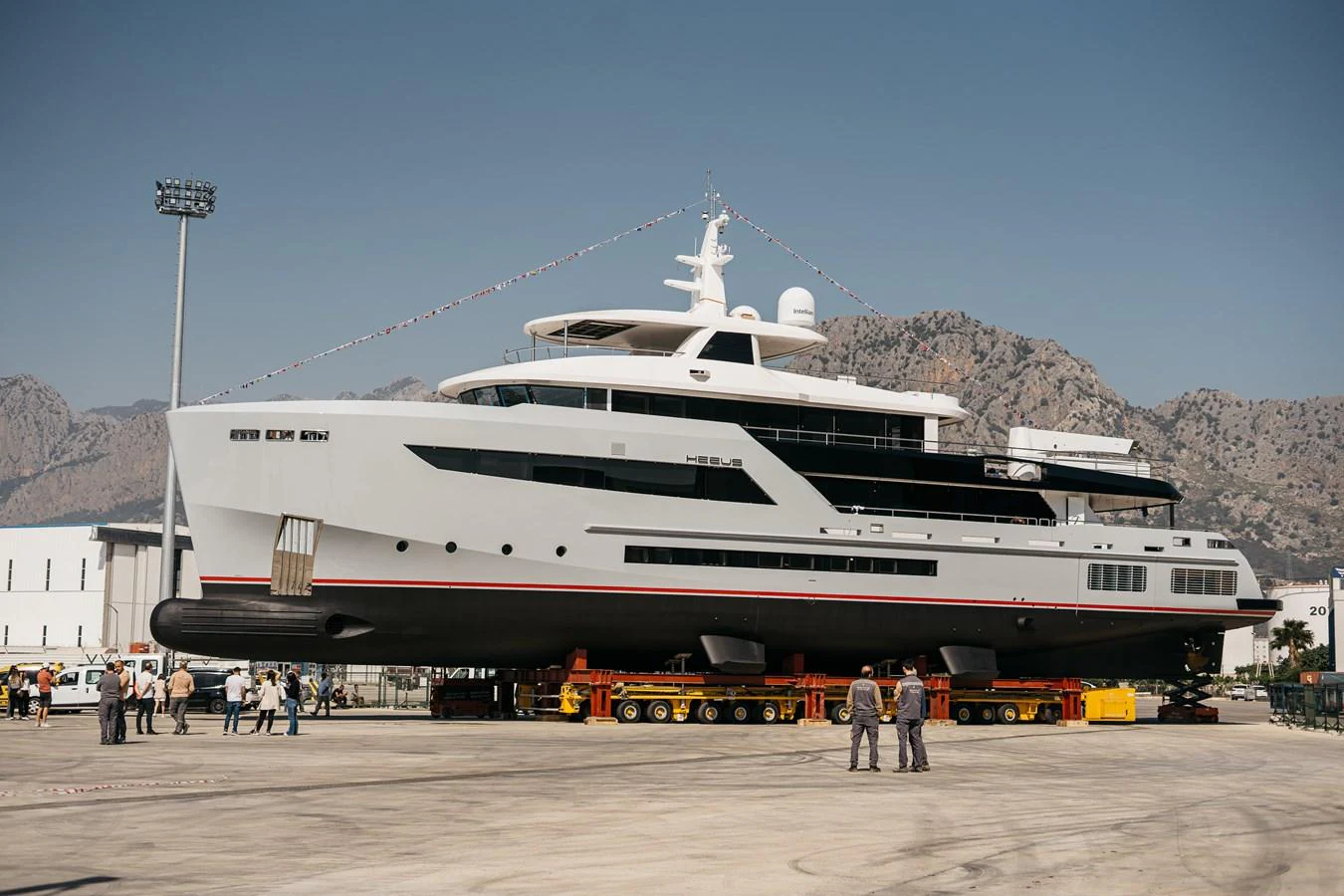 A sleek, modern yacht is showcased on a transport platform, ready for launch. aboard BERING 145 Yacht for Sale