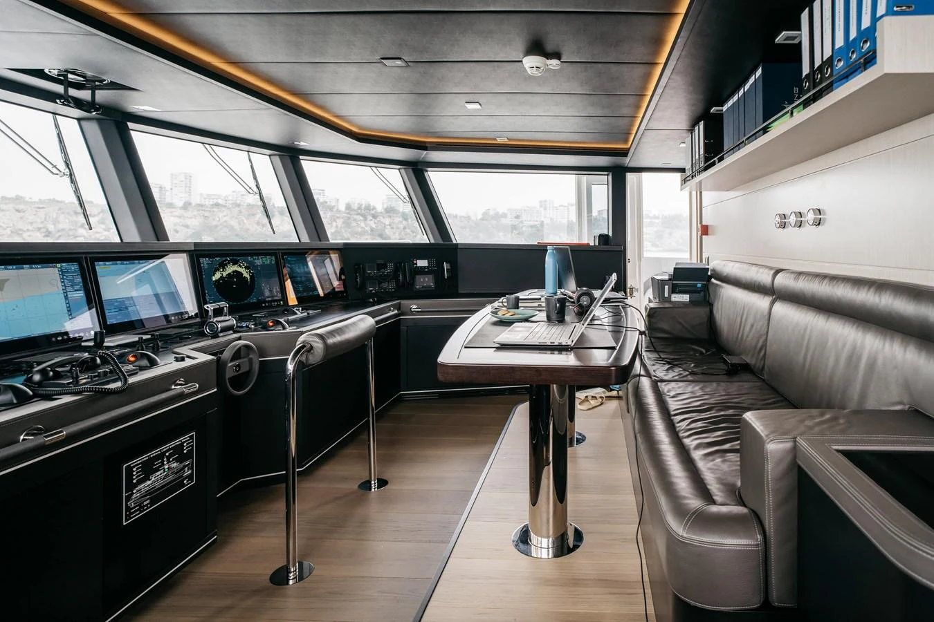 The helm station features advanced navigation equipment and a comfortable seating area for the captain. aboard BERING 145 Yacht for Sale