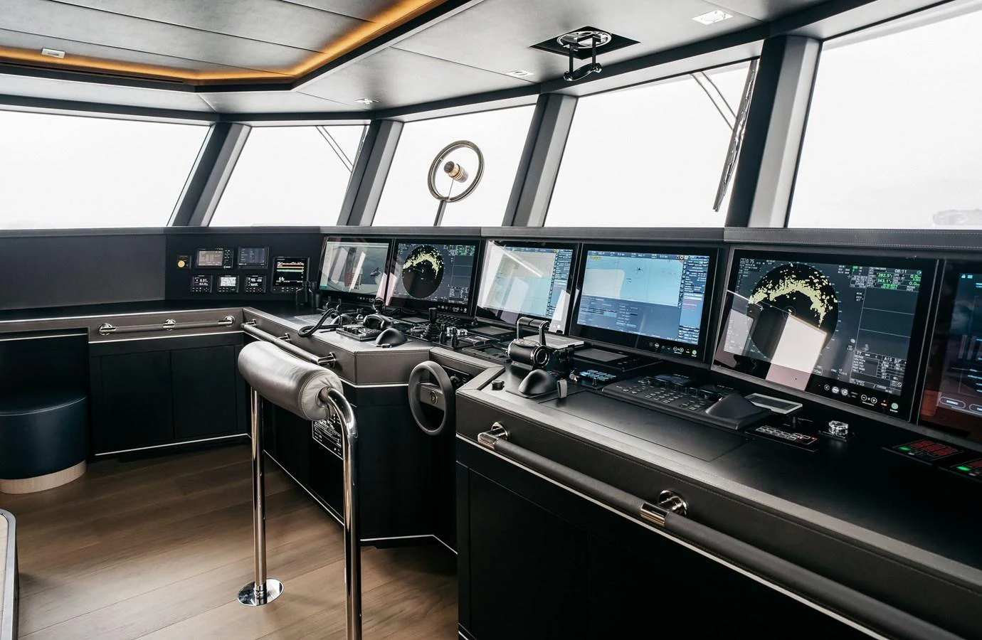 The helm station features advanced navigation equipment and a sleek, modern design. aboard BERING 145 Yacht for Sale